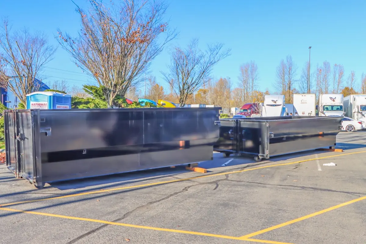 Professional dumpster rental service with roll-off container on residential driveway in Plumas Lake